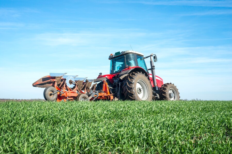 tractor-cultivating-field_342744-566